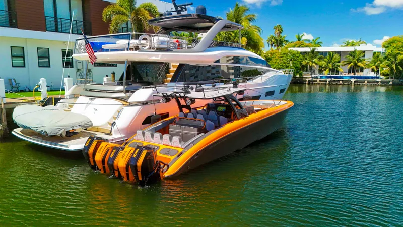  Yacht Photos Pics 2022 Midnight Express 43 Open boat docked beside a luxury yacht in a tropical setting.
