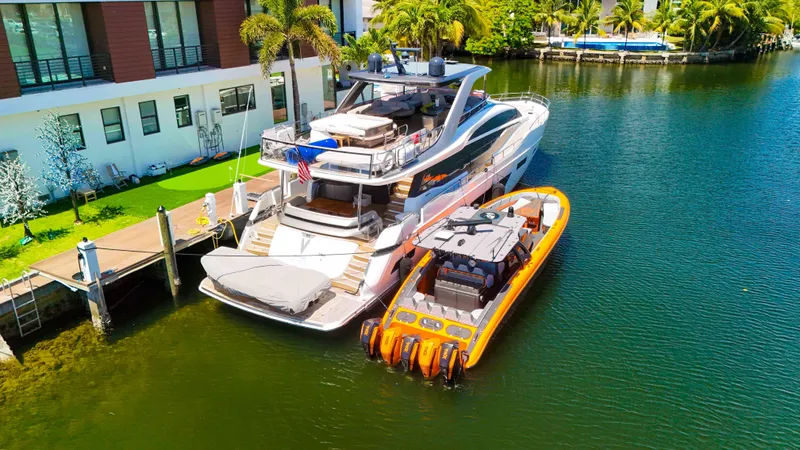  Yacht Photos Pics Luxury yacht and 2022 Midnight Express 43 Open docked by waterfront home.
