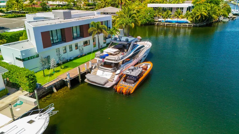  Yacht Photos Pics Luxury yachts docked by modern waterfront home, featuring 2022 Midnight Express 43 Open.