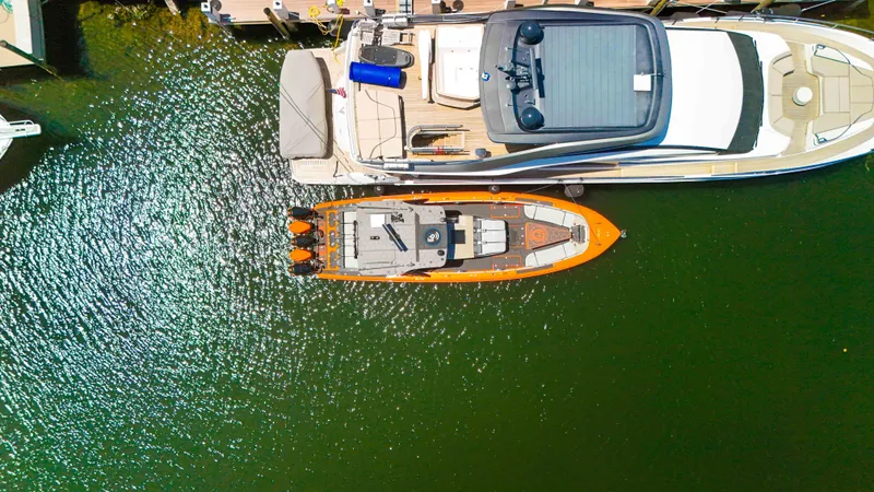  Yacht Photos Pics Aerial view of 2022 Midnight Express 43 Open boat docked beside a larger yacht.