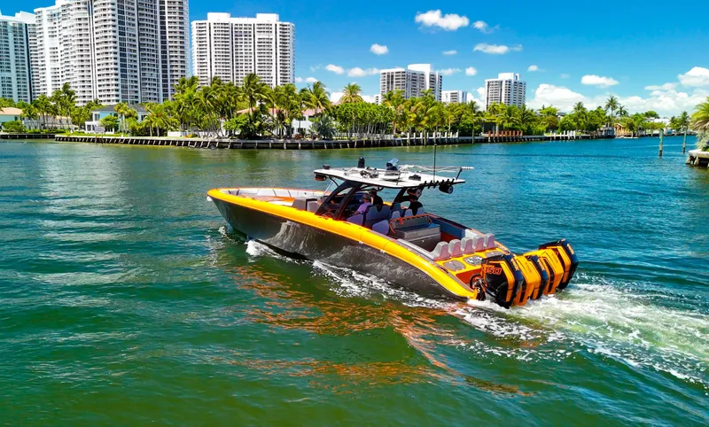  Yacht Photos Pics 2022 Midnight Express 43 Open boat cruising in a scenic waterfront cityscape.