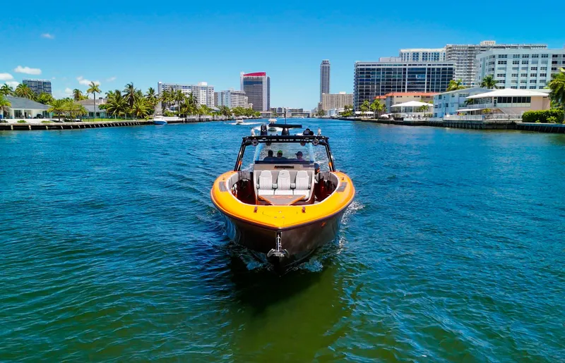  Yacht Photos Pics 2022 Midnight Express 43 Open boat cruising in a sunny urban waterway.