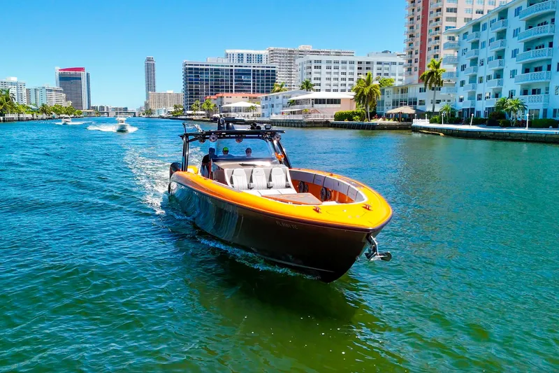  Yacht Photos Pics 2022 Midnight Express 43 Open boat cruising in a sunny urban waterway.