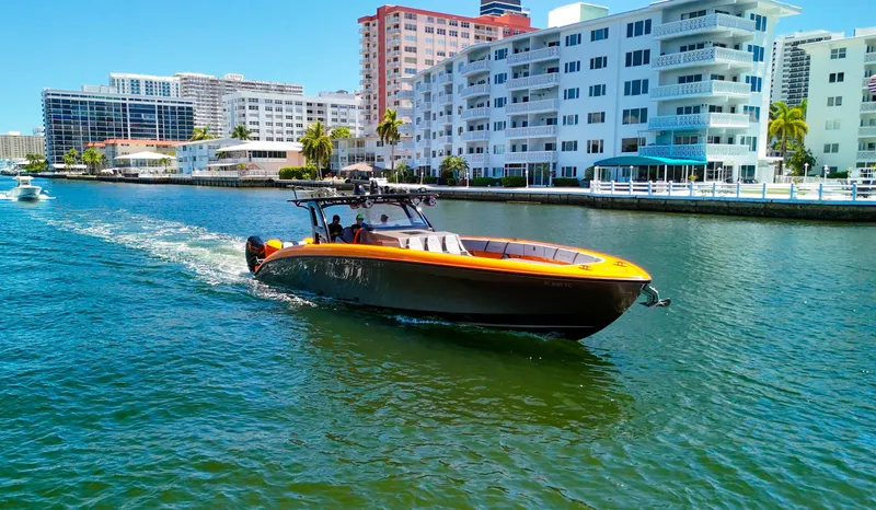  Yacht Photos Pics 2022 Midnight Express 43 Open boat cruising near waterfront buildings.