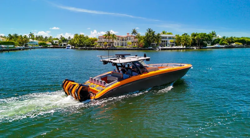  Yacht Photos Pics 2022 Midnight Express 43 Open boat cruising on a sunny day near waterfront homes.