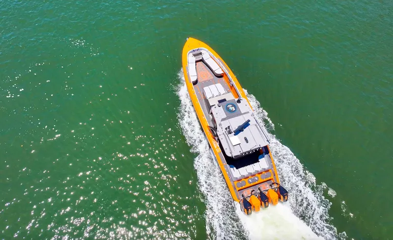  Yacht Photos Pics Aerial view of 2022 Midnight Express 43 Open boat cruising on green water.
