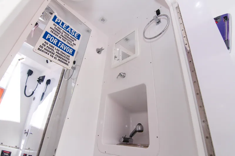  Yacht Photos Pics Interior of 2022 Midnight Express 43 Open boat bathroom with caution sign.