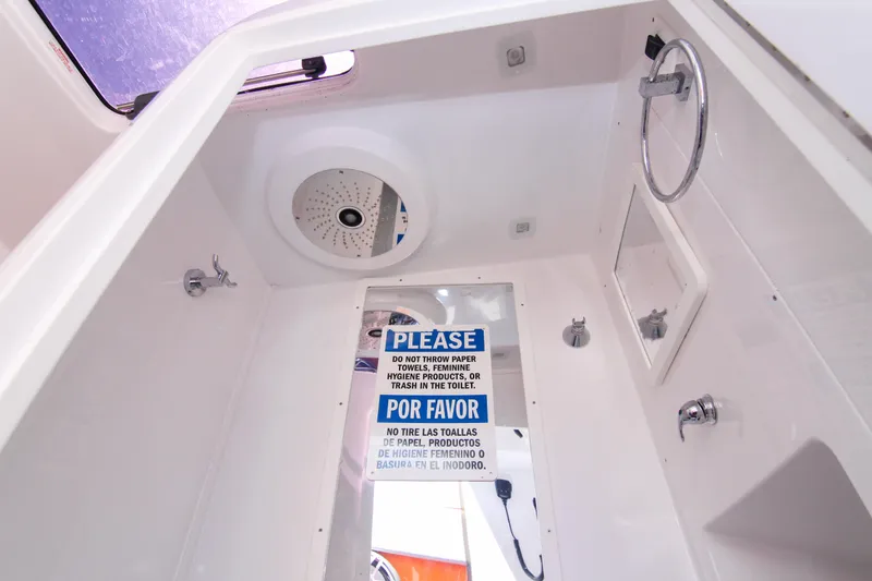  Yacht Photos Pics Interior of 2022 Midnight Express 43 Open boat bathroom with caution sign.