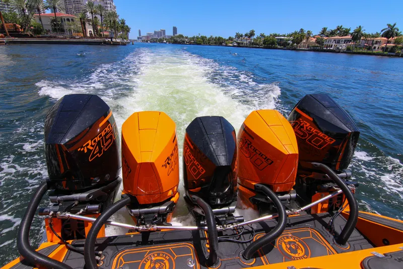  Yacht Photos Pics 2022 Midnight Express 43 Open boat with four powerful outboard engines on a sunny waterway.