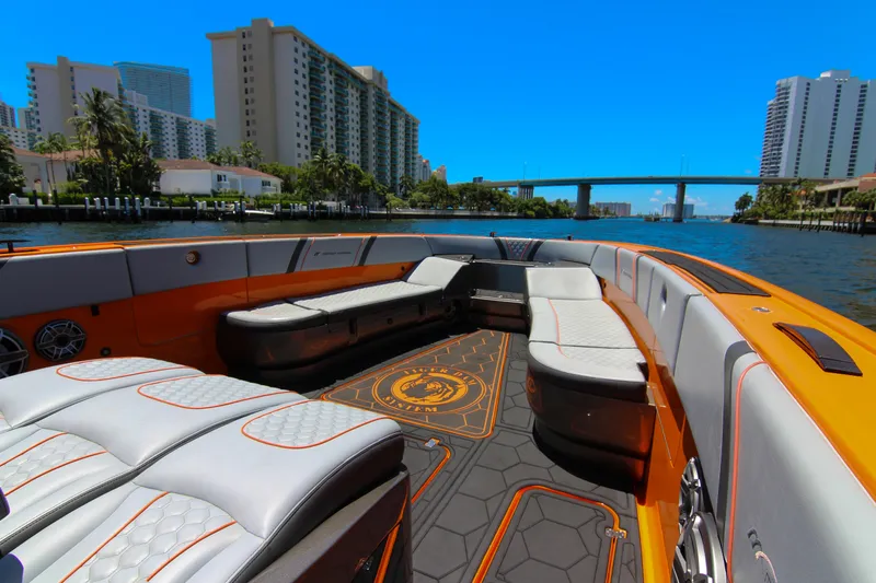  Yacht Photos Pics 2022 Midnight Express 43 Open boat interior with luxurious seating and vibrant orange accents.