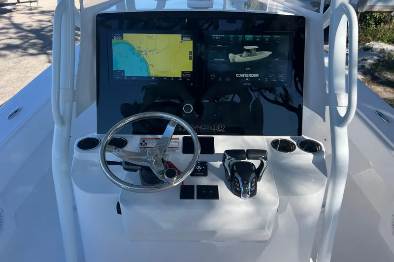  Yacht Photos Pics 2026 Contender 29 Bay boat dashboard with dual screens and steering wheel.