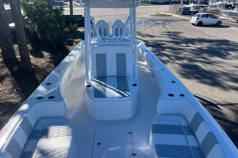  Yacht Photos Pics 2026 Contender 29 Bay boat interior with seating and console, parked outdoors.