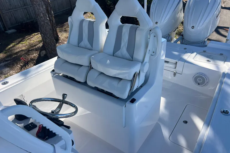  Yacht Photos Pics 2026 Contender 29 Bay boat interior with dual white seats and steering wheel.