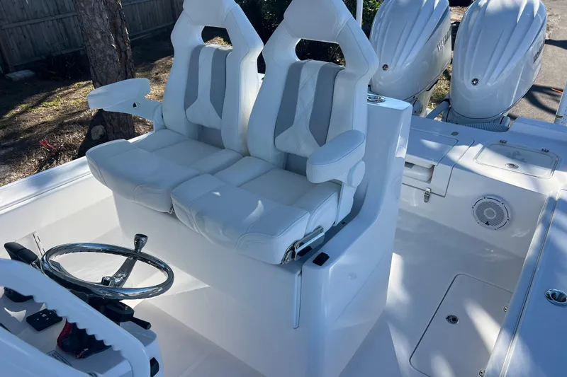  Yacht Photos Pics 2026 Contender 29 Bay boat interior with dual seats and steering wheel.