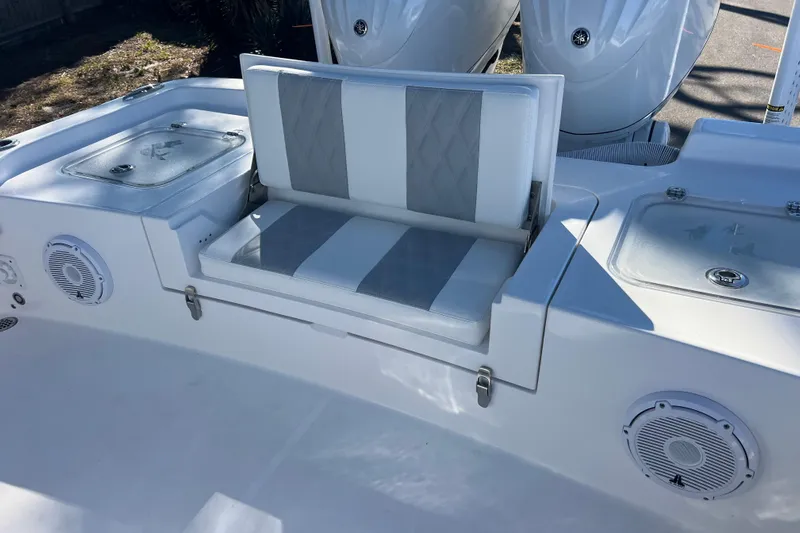  Yacht Photos Pics 2026 Contender 29 Bay boat seating area with storage compartments and speakers.