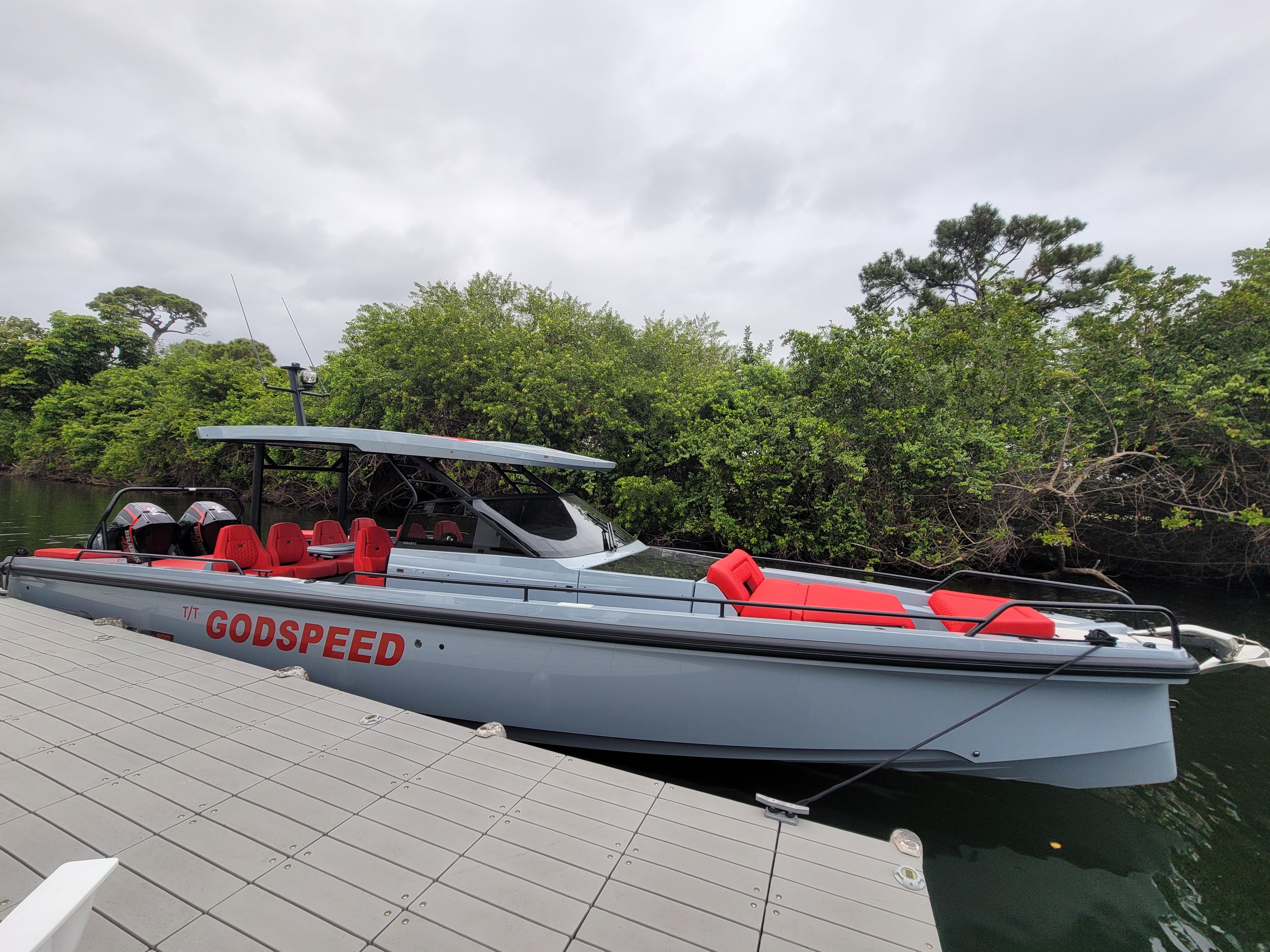 2022 BRABUS Shadow 900 ST boat docked near lush greenery.