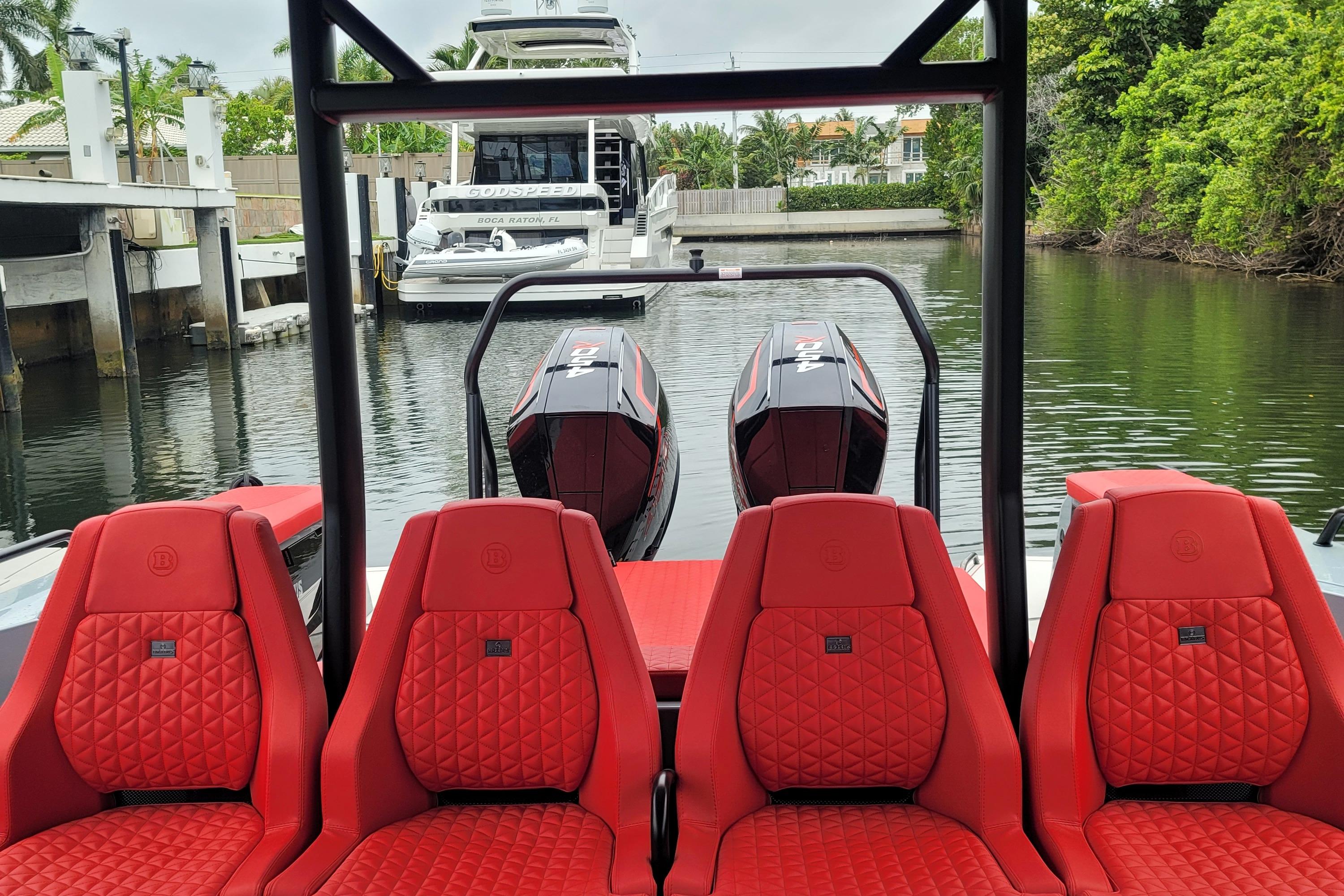 2022 BRABUS Shadow 900 ST with red seats docked in a marina.