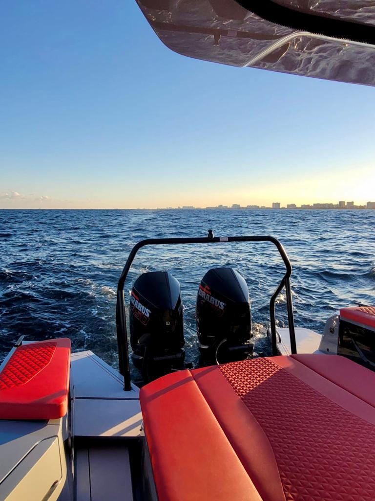 2022 BRABUS Shadow 900 ST boat with twin engines on open water at sunset.