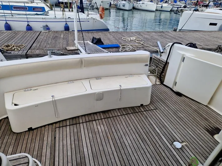  Yacht Photos Pics Jeanneau PRESTIGE 32 FLY 2005 yacht deck with seating, docked at marina.