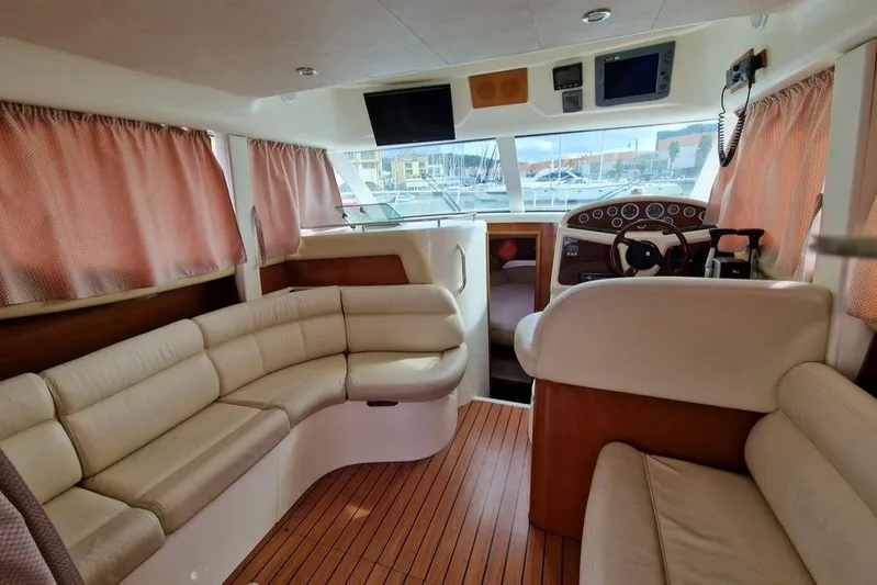  Yacht Photos Pics Interior of 2005 Jeanneau PRESTIGE 32 FLY yacht with plush seating and navigation controls.