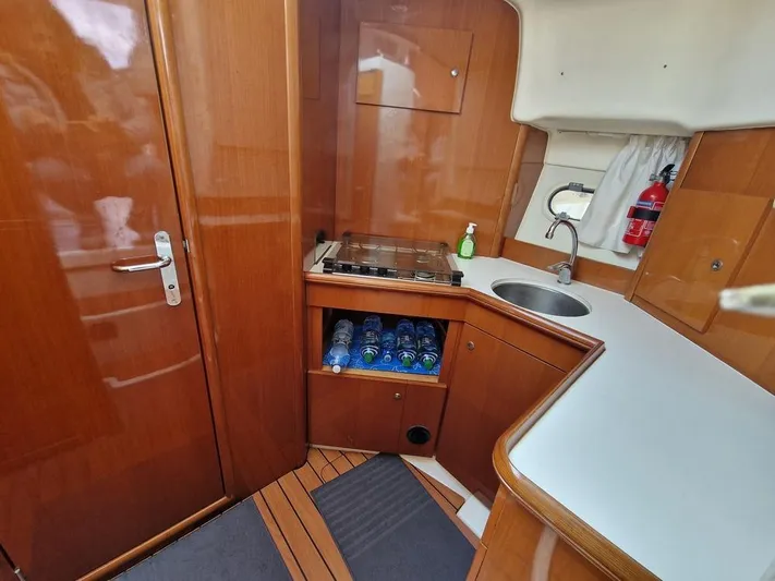  Yacht Photos Pics Interior of 2005 Jeanneau PRESTIGE 32 FLY yacht, featuring compact kitchen area.