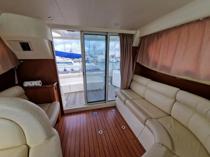  Yacht Photos Pics Interior of 2005 Jeanneau PRESTIGE 32 FLY yacht with leather seating and wooden flooring.