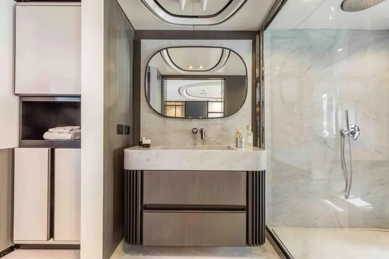 L.a.u.l. Yacht Photos Pics Luxurious bathroom with modern vanity, large mirror, and glass shower in 2019 ISA Extra 130 Alloy.