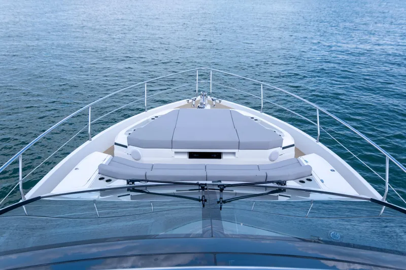 Madness V Yacht Photos Pics Bow view of 2022 Pearl 62 yacht on calm water.