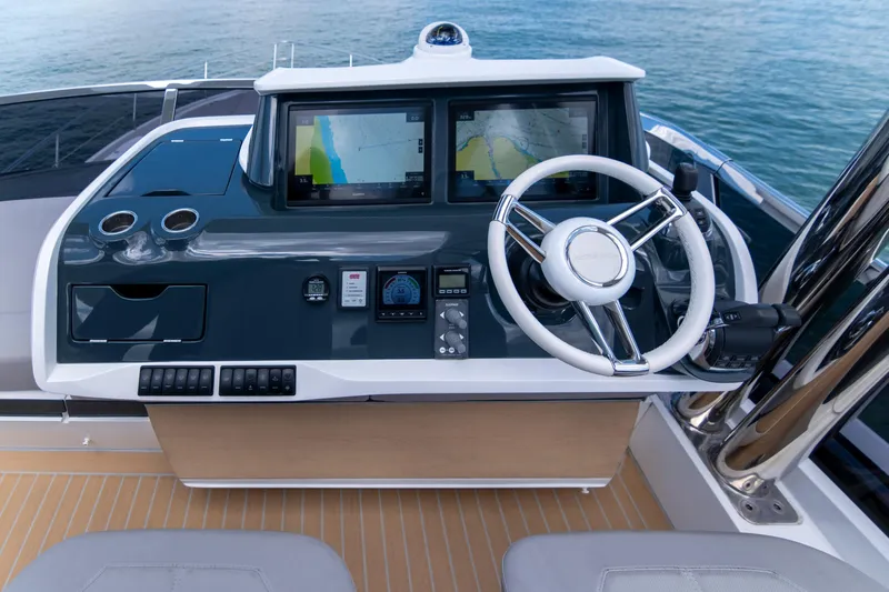 Madness V Yacht Photos Pics Helm of 2022 Pearl 62 yacht with dual navigation screens and steering wheel.