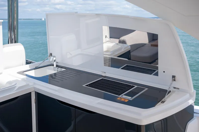 Madness V Yacht Photos Pics Outdoor kitchen on Pearl 62 yacht, featuring grill and sink, ocean view.