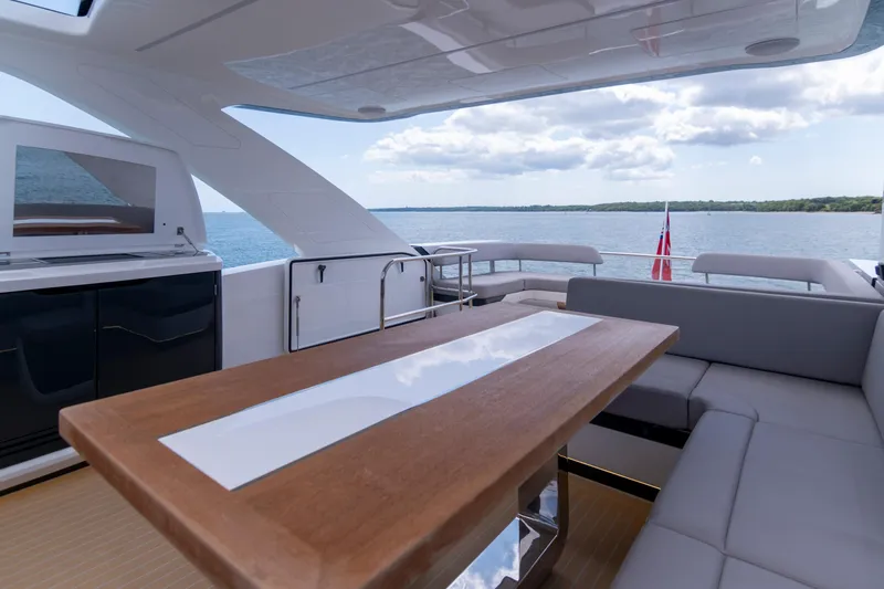 Madness V Yacht Photos Pics Luxurious Pearl 62 yacht interior with modern seating and ocean view, 2022 model.