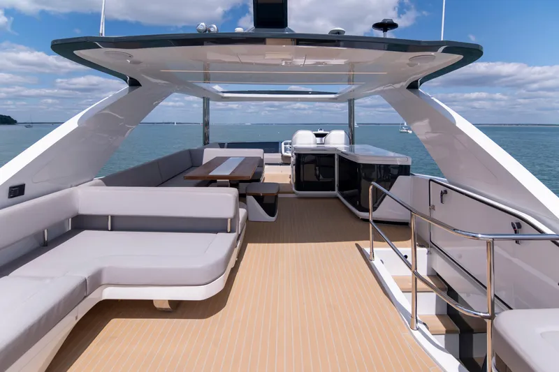 Madness V Yacht Photos Pics Luxurious Pearl 62 yacht deck with modern seating, ocean view, and sleek design, 2022 model.