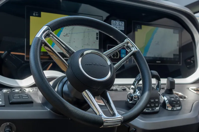 Madness V Yacht Photos Pics Steering wheel and dashboard of 2022 Pearl 62 yacht with navigation screens.