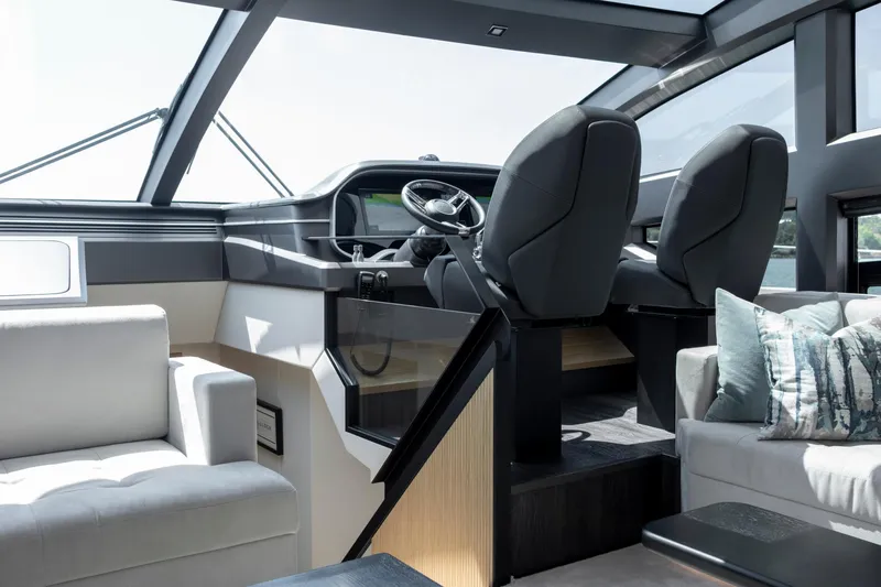 Madness V Yacht Photos Pics Luxurious interior of 2022 Pearl 62 yacht with modern helm and seating area.