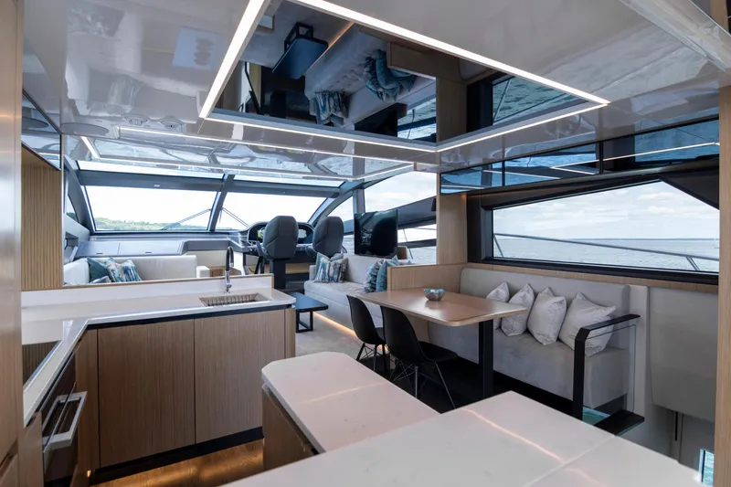 Madness V Yacht Photos Pics Luxurious interior of 2022 Pearl 62 yacht with modern design and panoramic windows.