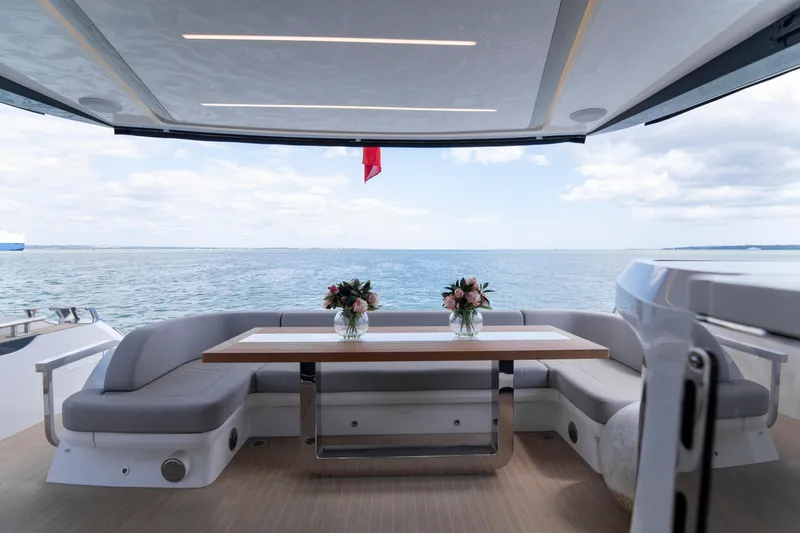 Madness V Yacht Photos Pics Luxurious Pearl 62 yacht interior with ocean view, featuring elegant seating and floral arrangements.