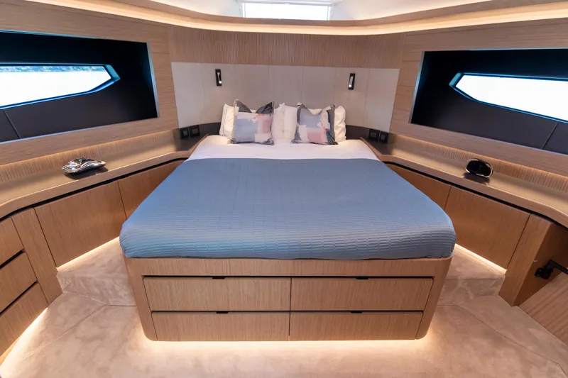 Madness V Yacht Photos Pics Luxurious bedroom interior on 2022 Pearl 62 yacht with modern design and ambient lighting.