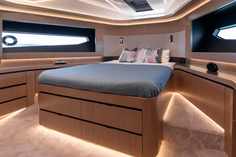Madness V Yacht Photos Pics Luxurious bedroom interior of 2022 Pearl 62 yacht with modern design and ambient lighting.
