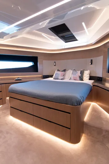Madness V Yacht Photos Pics Luxurious bedroom interior on 2022 Pearl 62 yacht with modern design and ambient lighting.