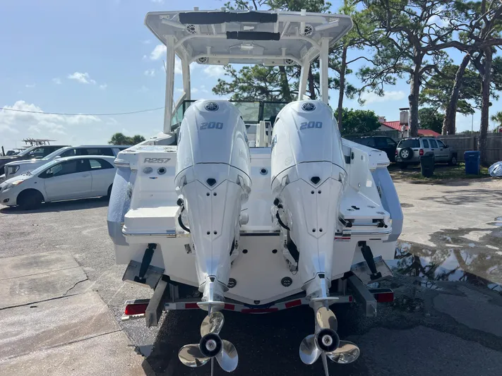  Yacht Photos Pics 2025 Robalo R257 Dual Console boat with twin 200 horsepower engines, parked outdoors.