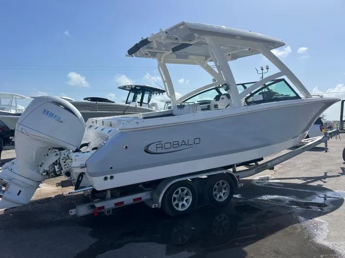  Yacht Photos Pics 2025 Robalo R257 Dual Console boat on trailer under clear sky.