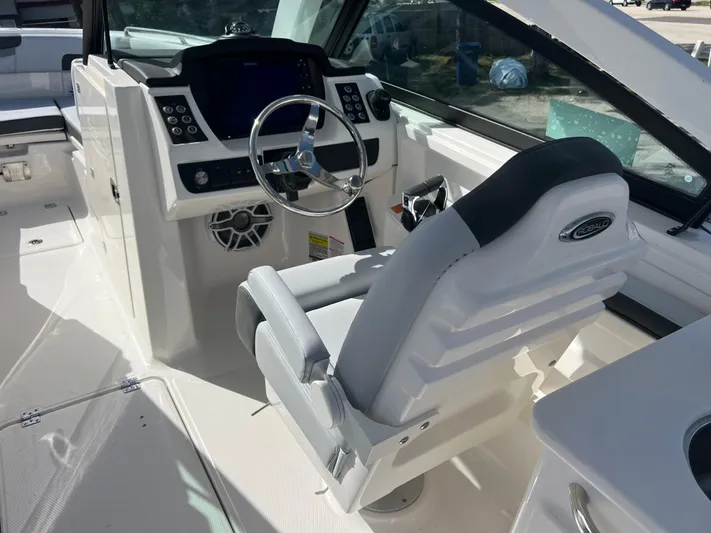  Yacht Photos Pics 2025 Robalo R257 Dual Console boat interior with steering wheel and control panel.