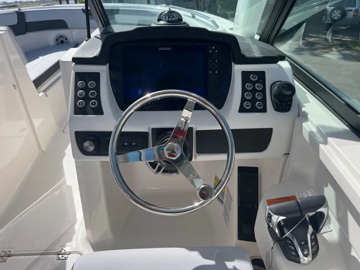  Yacht Photos Pics 2025 Robalo R257 Dual Console boat dashboard with steering wheel and control panel.