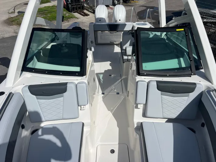  Yacht Photos Pics 2025 Robalo R257 Dual Console boat interior with seating and windshield.