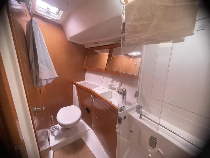 Metis Yacht Photos Pics Bathroom interior of 2012 Beneteau Sense 43 yacht, featuring modern fixtures and wooden cabinetry.