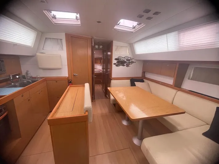 Metis Yacht Photos Pics Luxurious interior of 2012 Beneteau Sense 43 yacht with modern dining area and kitchen.