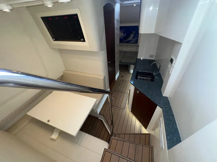 Wooocrew Yacht Photos Pics Interior of 2015 SeaVee 43 Fish-Around boat with modern kitchen and seating area.