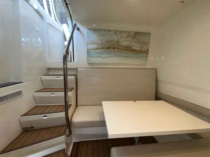 Wooocrew Yacht Photos Pics Interior of 2015 SeaVee 43 Fish-Around with seating and table, featuring modern design.