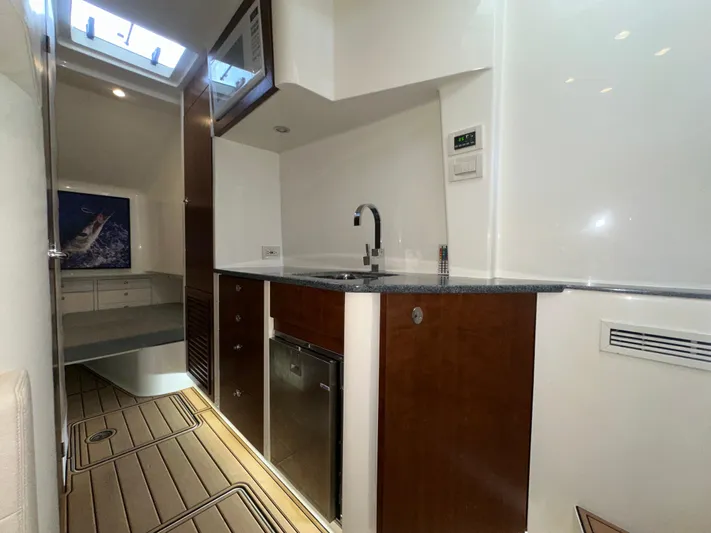 Wooocrew Yacht Photos Pics 2015 SeaVee 43 Fish-Around interior with kitchenette, wood cabinets, and skylight.