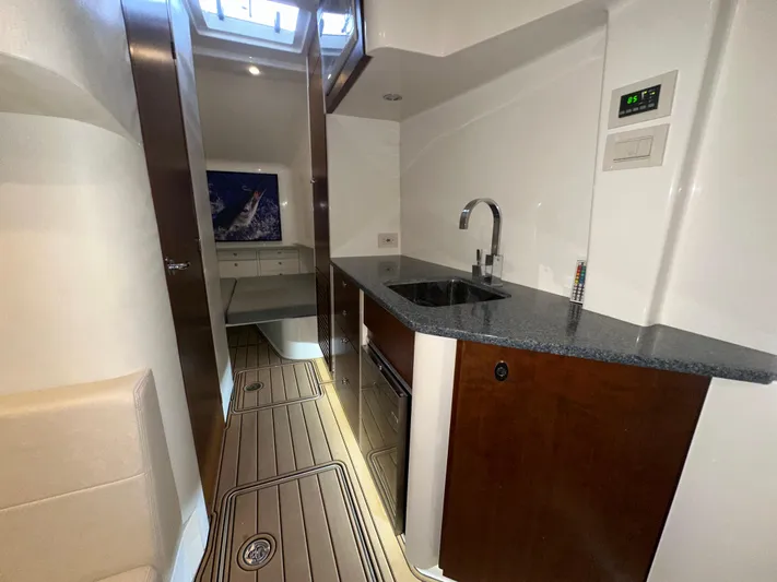 Wooocrew Yacht Photos Pics 2015 SeaVee 43 Fish-Around interior with modern kitchenette and wood accents.